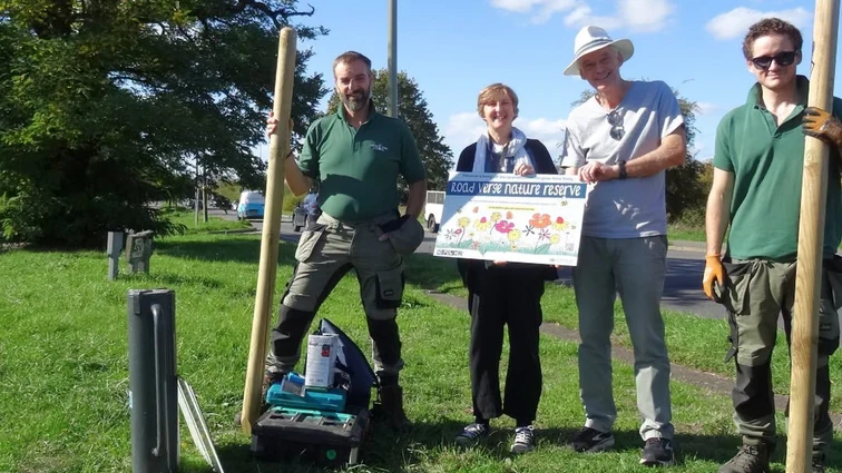 Putting up the Road Verge Nature Reserve sign on the Burford Road verge in Witney